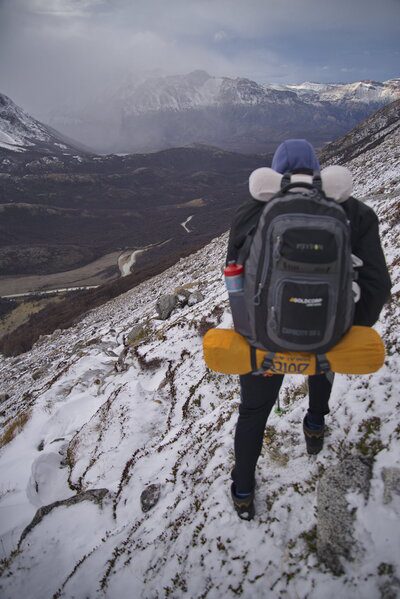 a man hiking on a mountain with snow