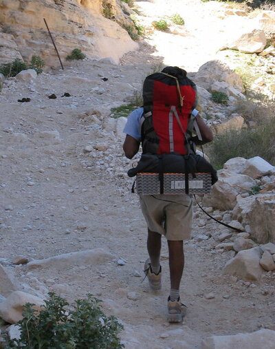 a guy thru hiking on a rocky terrain