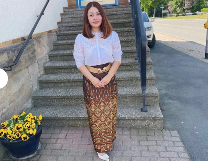 Woman wearing beautiful hand embroidered Thai dress