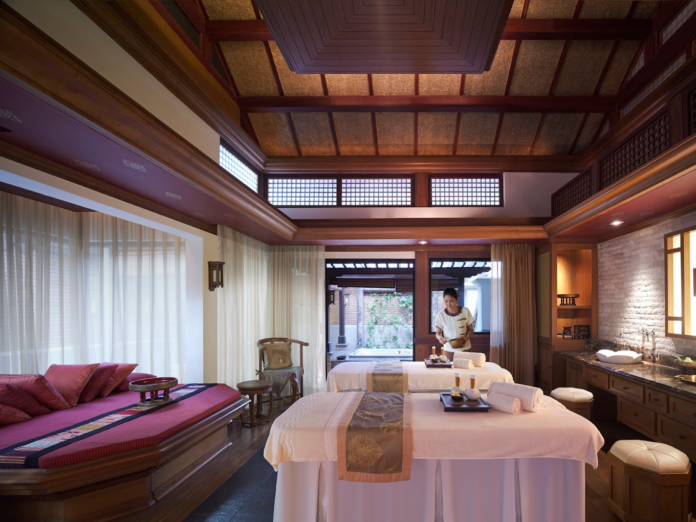 Massage therapist getting the private room ready for a full body massage