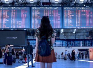 How to Talk to a Girl on Flight: Tips and Advice for Initiating and Making a Meaningful Conversation Woman in Front of Airport Departures Screen